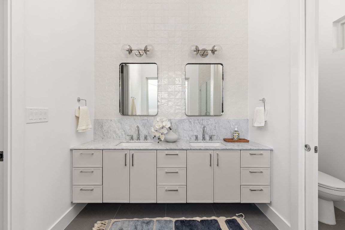 127 Frederick Street Austin, TX 78704 - Photo 18 of 35 a bathroom with a double vanity sink and mirror