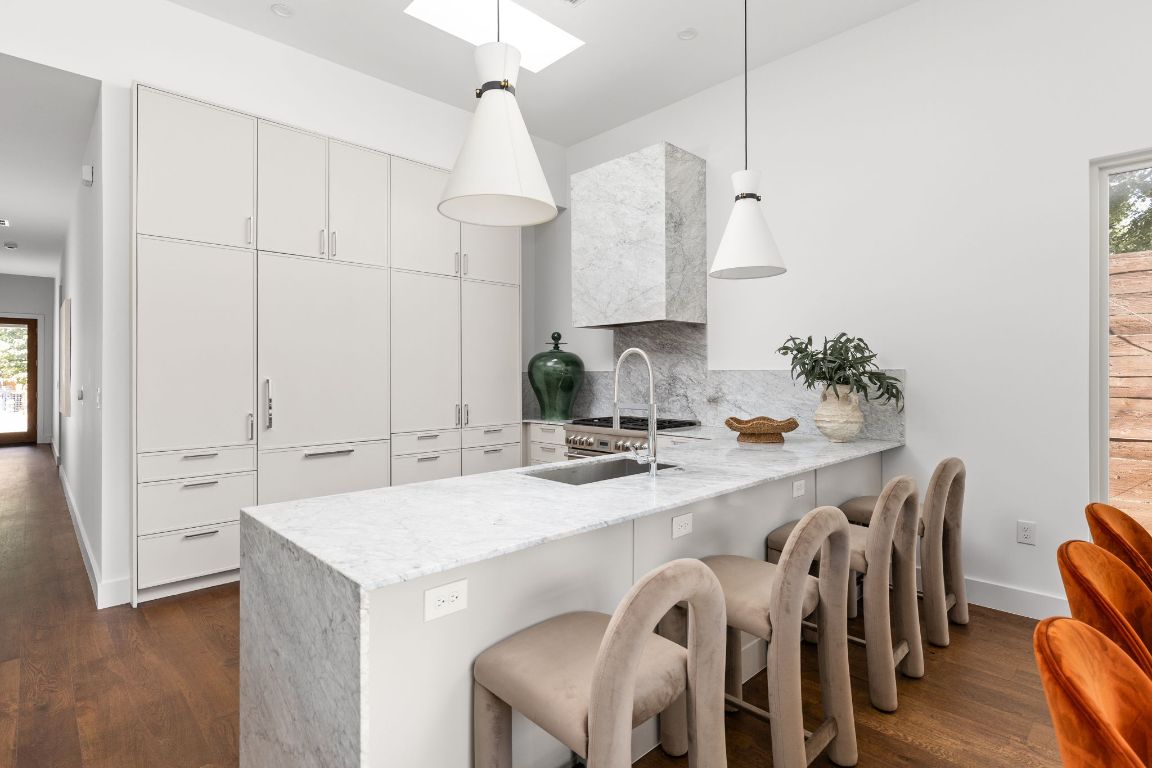 127 Frederick Street Austin, TX 78704 - Photo 10 of 35 a kitchen with stainless steel appliances granite countertop a sink a stove a dining table and chairs