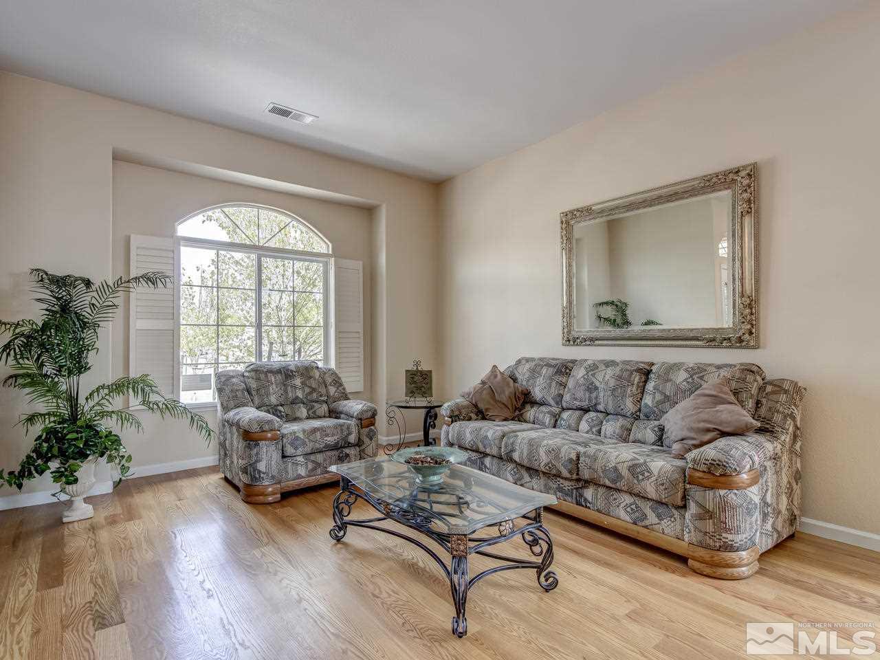1114 University Ridge Drive Reno, NV 89512 - Photo 4 of 25 a living room with furniture and a large window