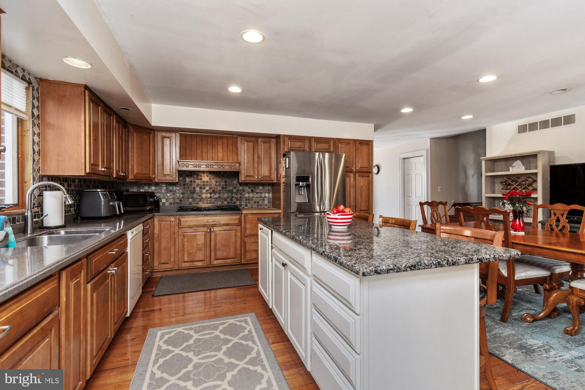 9202 Santa Rita Road Baltimore, MD 21236 - Photo 12 of 50 a kitchen with stainless steel appliances granite countertop a sink stove and cabinets