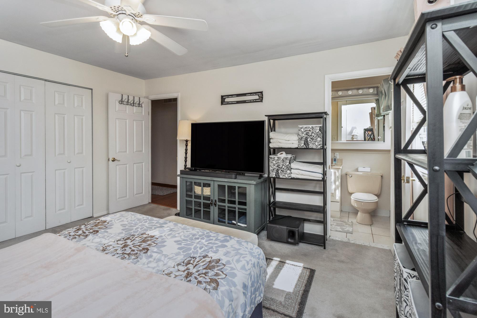 9202 Santa Rita Road Baltimore, MD 21236 - Photo 19 of 50 a bedroom with a bed and a flat screen tv