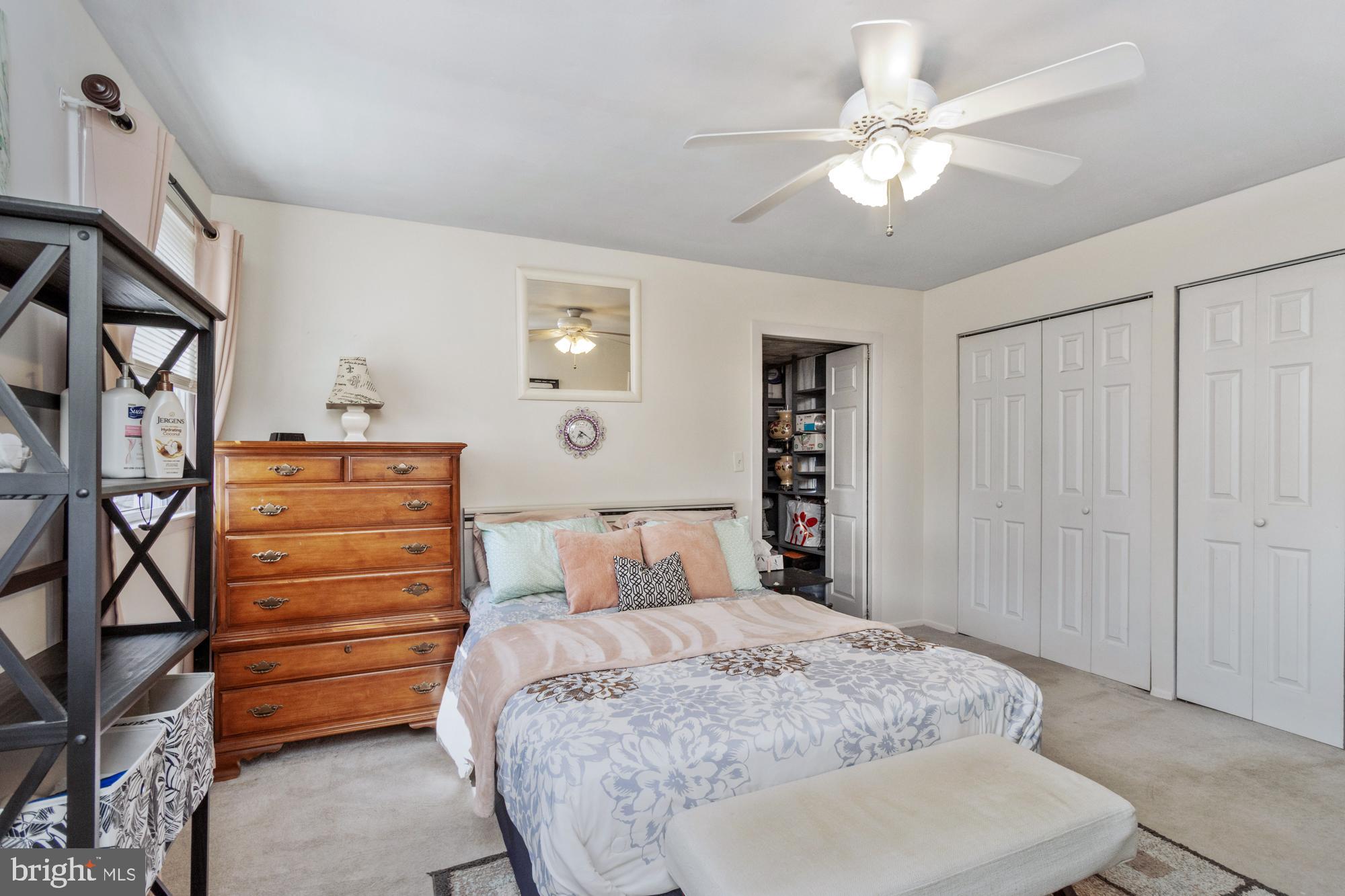 9202 Santa Rita Road Baltimore, MD 21236 - Photo 20 of 50 a bedroom with a bed a dresser and a chandelier