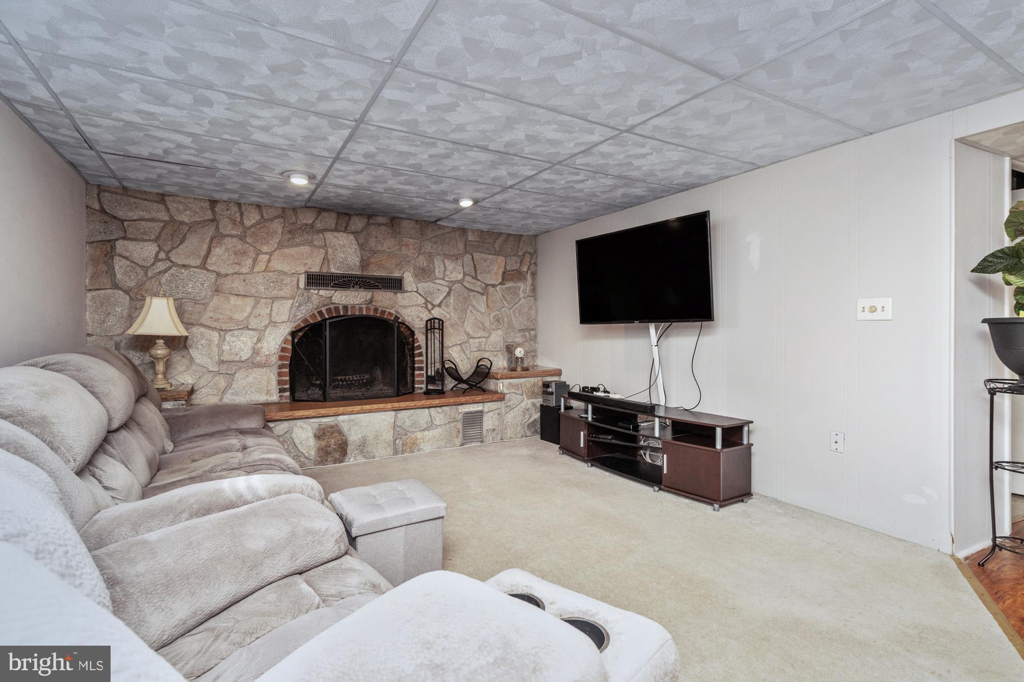 9202 Santa Rita Road Baltimore, MD 21236 - Photo 30 of 50 a living room with furniture and a flat screen tv