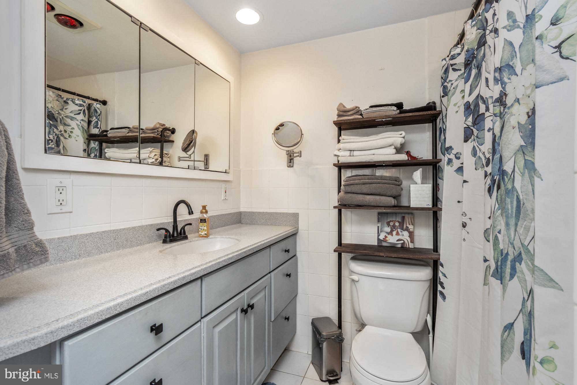 9202 Santa Rita Road Baltimore, MD 21236 - Photo 37 of 50 a bathroom with a sink toilet and mirror