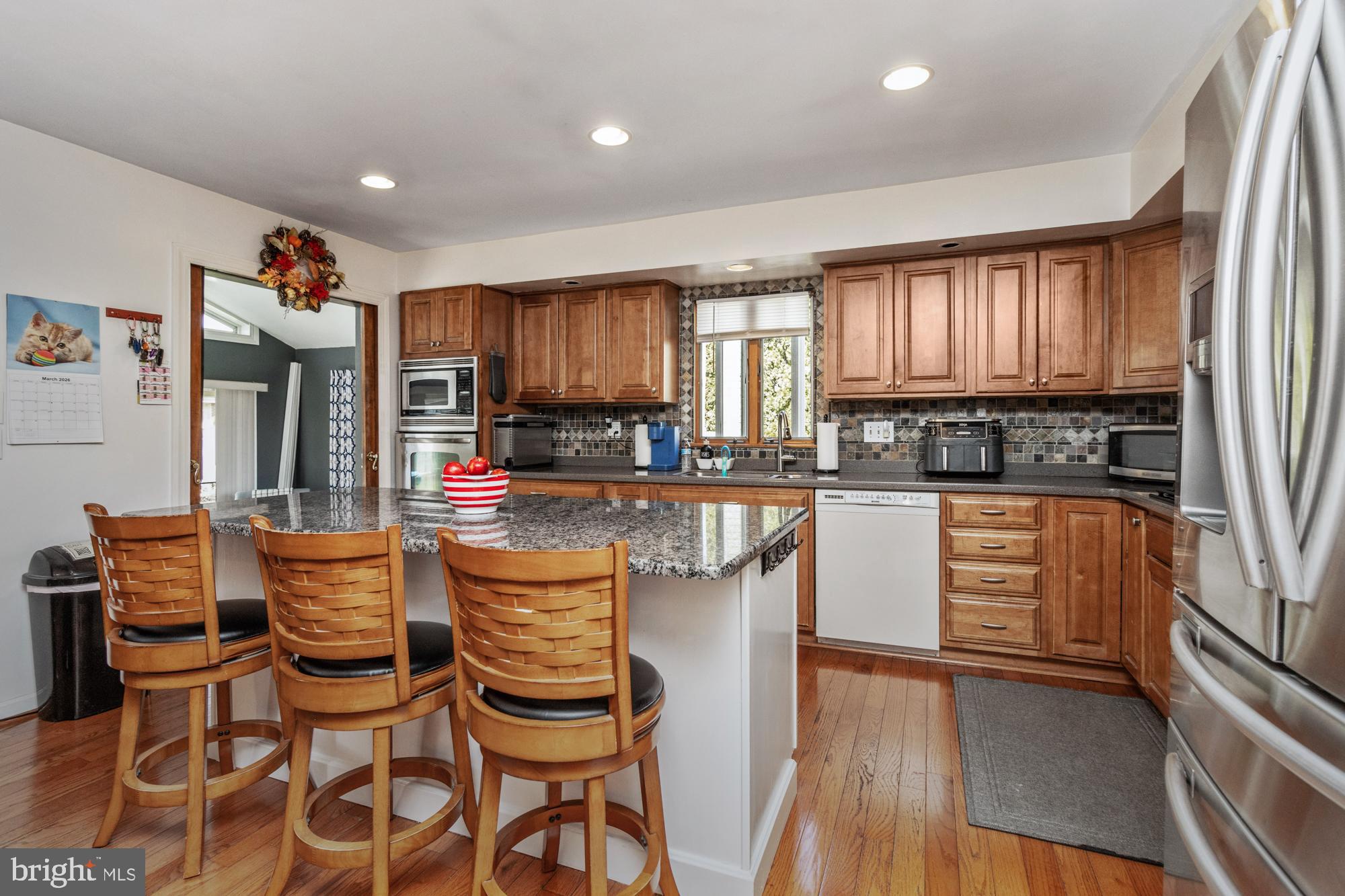 9202 Santa Rita Road Baltimore, MD 21236 - Photo 10 of 50 a kitchen with stainless steel appliances kitchen island granite countertop a stove a sink and a refrigerator