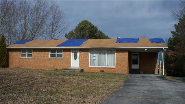 519 West Point Road Lawrenceburg, TN 38464 - Photo 1 of 4 a front view of a house with a yard and garage