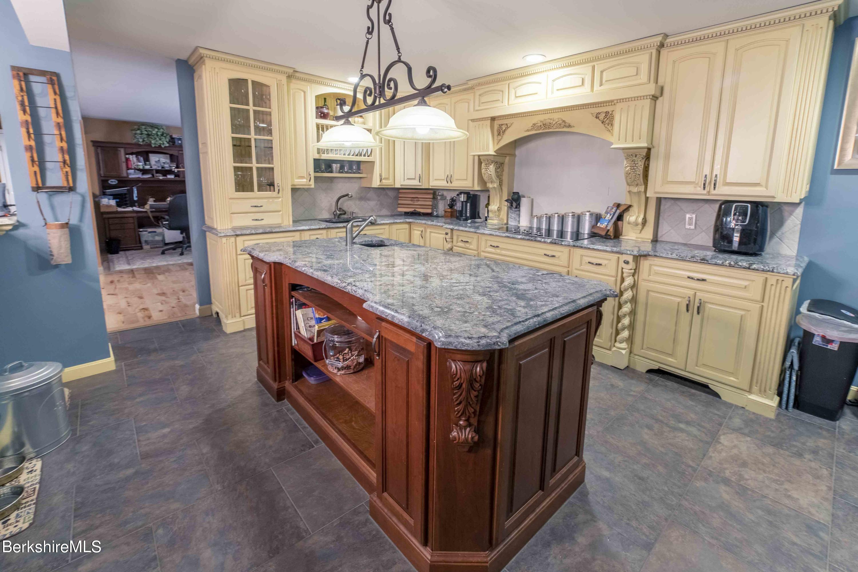 82 Pine Ridge Drive Pownal, VT 05261 - Photo 14 of 35 a kitchen with stainless steel appliances granite countertop a kitchen island a stove and a sink