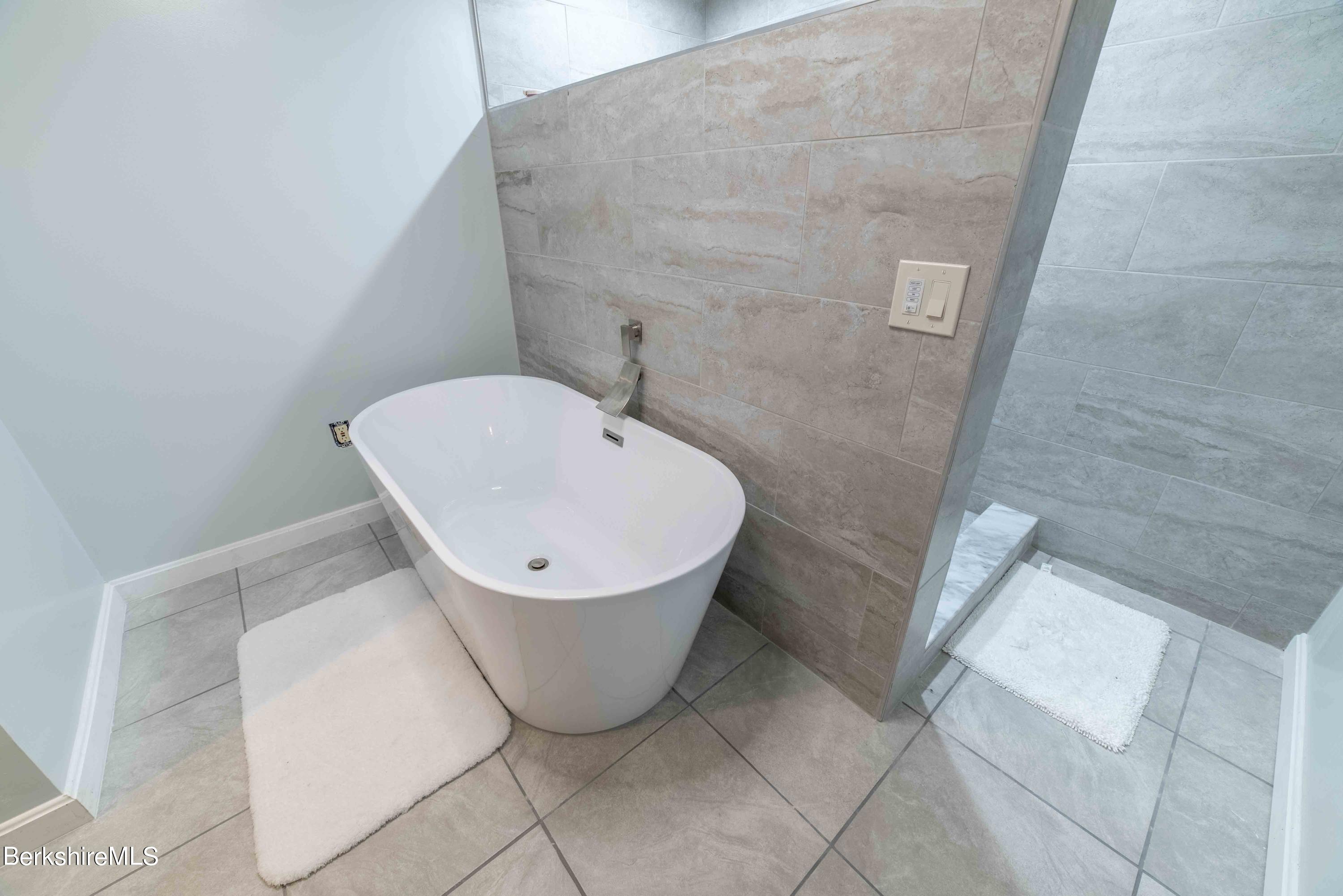 82 Pine Ridge Drive Pownal, VT 05261 - Photo 22 of 35 a bathroom with a sink and mirror