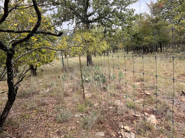 a view of yard with wooden fence