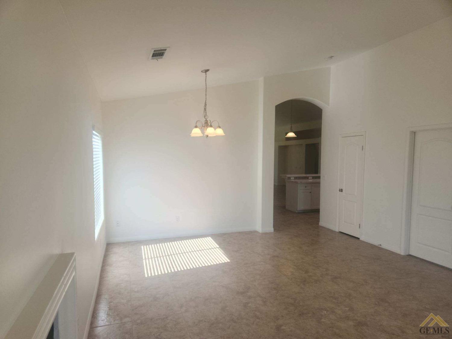 Undisclosed Address Bakersfield, CA 93311 - Photo 3 of 9 a view of empty room with a windows and cabinet