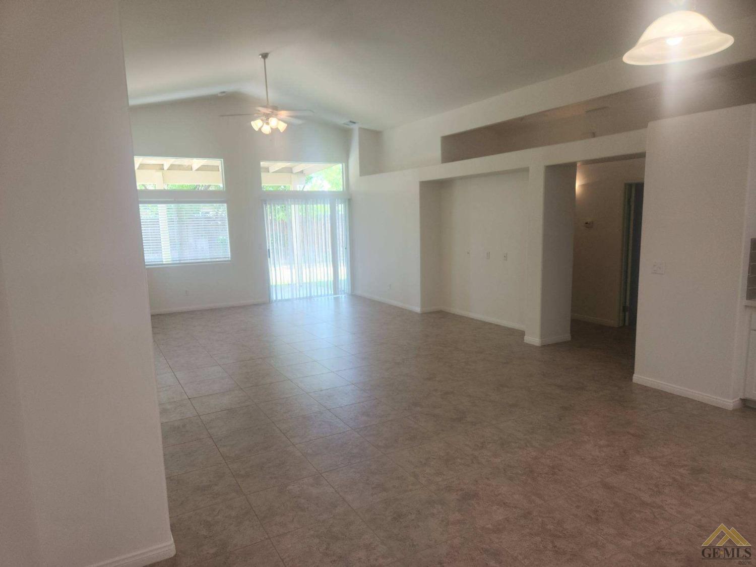 Undisclosed Address Bakersfield, CA 93311 - Photo 4 of 9 an empty room with wooden floor and windows
