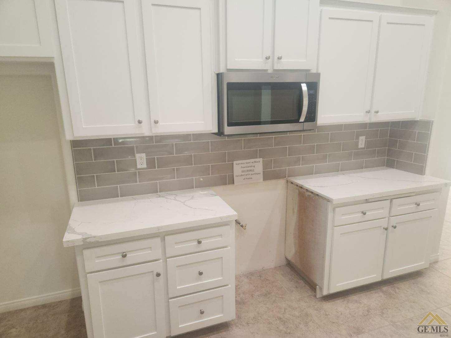 Undisclosed Address Bakersfield, CA 93311 - Photo 7 of 9 a kitchen with white cabinets and sink