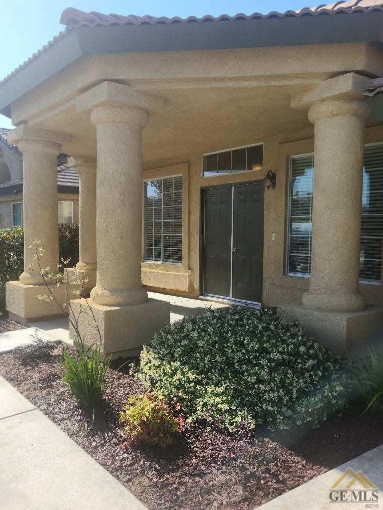 Undisclosed Address Bakersfield, CA 93311 - Photo 9 of 9 a front view of a house with a yard and garage