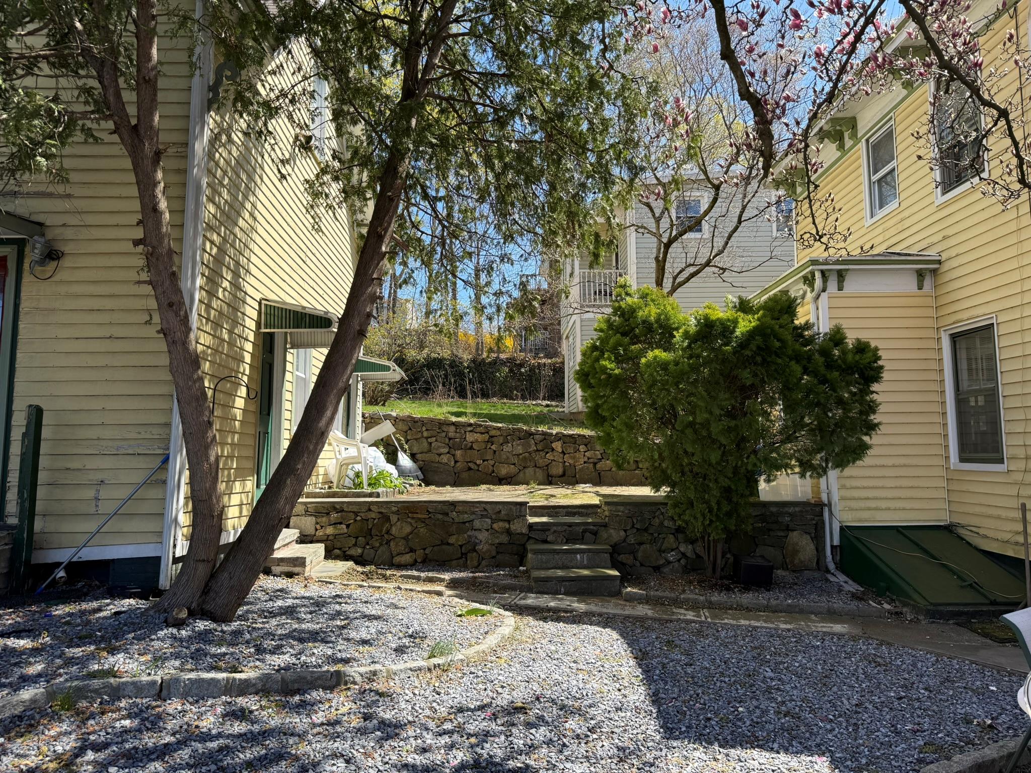 1204 Main Street Peekskill, NY 10566 - Photo 16 of 21 a view of backyard with wooden fence and a large tree
