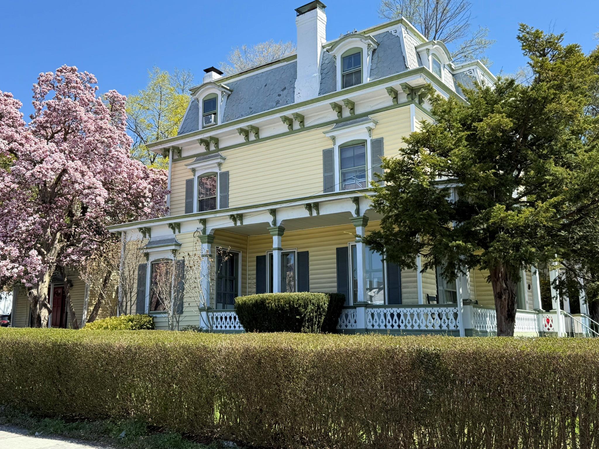 1204 Main Street Peekskill, NY 10566 - Photo 2 of 21 a view of a white house with large windows and a tree