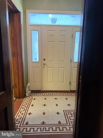 a view of a room with wooden floor and furniture