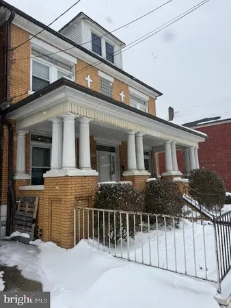 a front view of a house with a fence