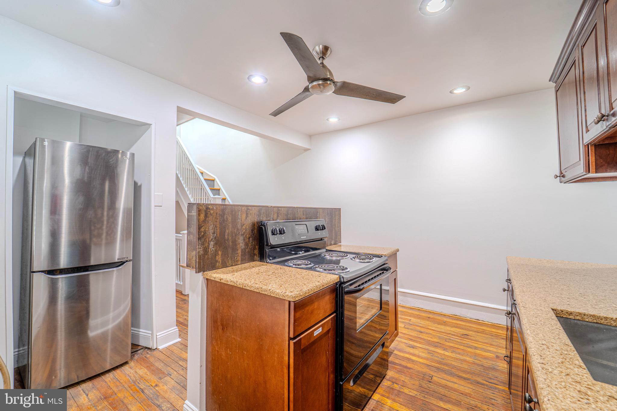225 South 49th Street, Unit 2 Philadelphia, PA 19139 - Photo 1 of 26 a kitchen that has a microwave a stove and a refrigerator