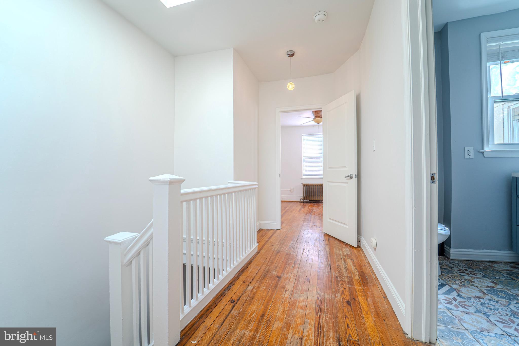 225 South 49th Street, Unit 2 Philadelphia, PA 19139 - Photo 16 of 26 a view of a hallway with wooden floor and staircase