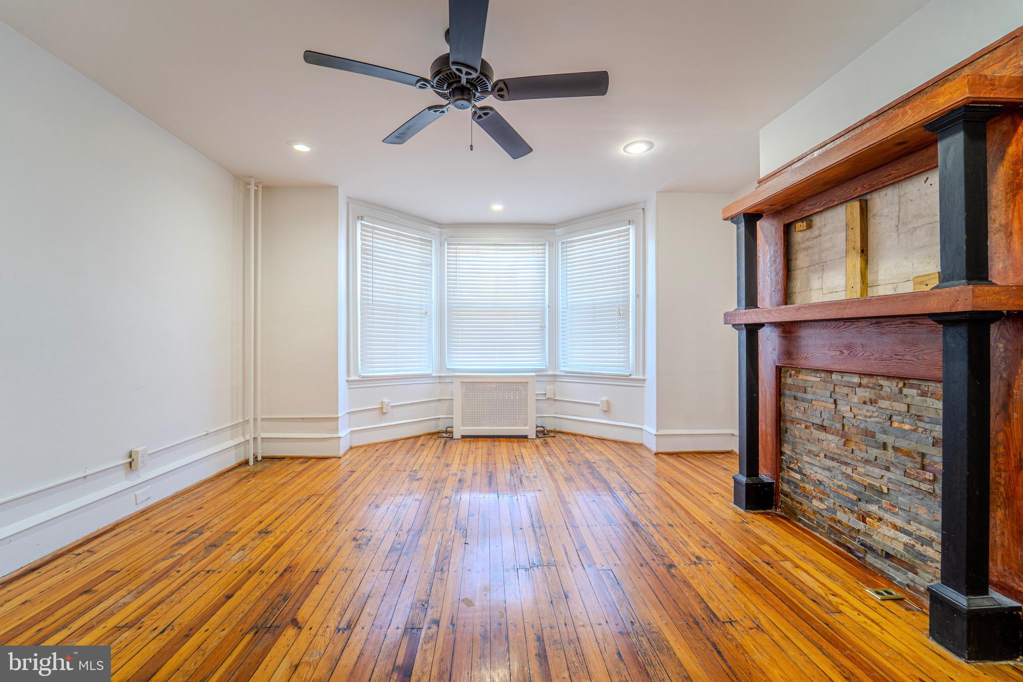225 South 49th Street, Unit 2 Philadelphia, PA 19139 - Photo 4 of 26 a view of empty room with wooden floor and fan