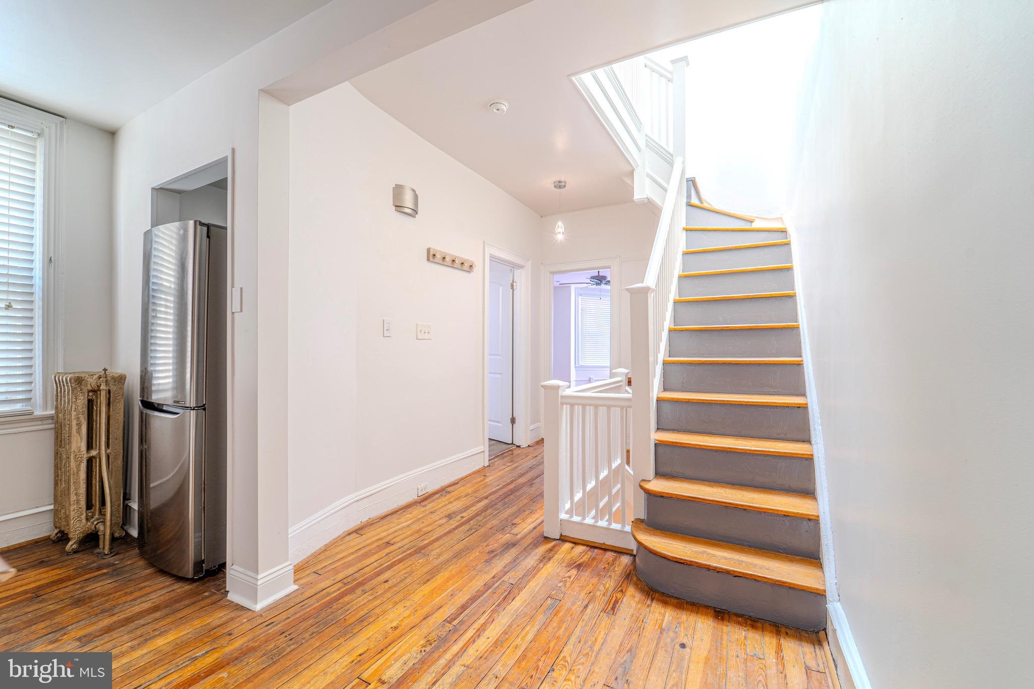 225 South 49th Street, Unit 2 Philadelphia, PA 19139 - Photo 5 of 26 a view of entryway with wooden floor and stairs