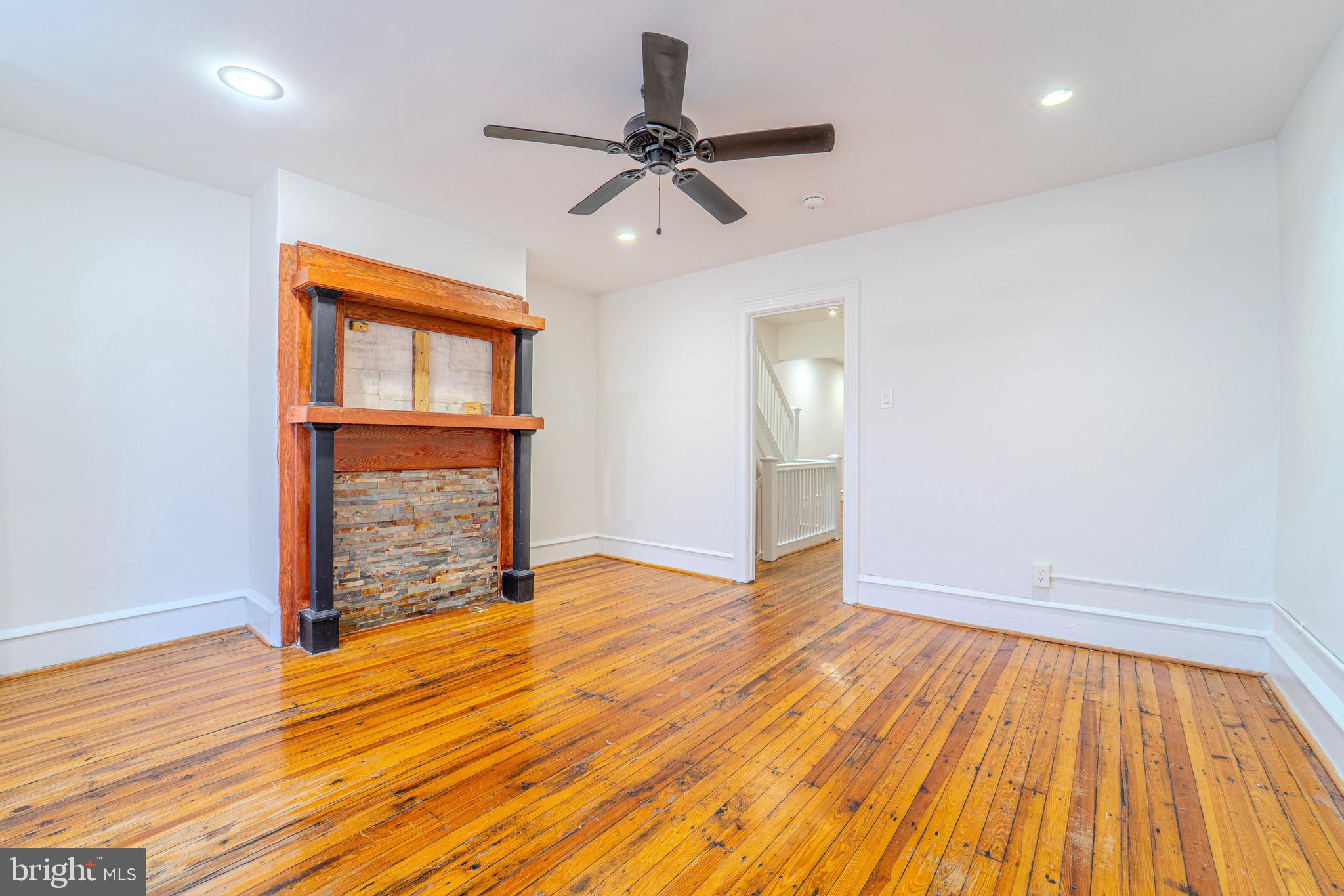 225 South 49th Street, Unit 2 Philadelphia, PA 19139 - Photo 8 of 26 a view of an empty room with wooden floor and a window