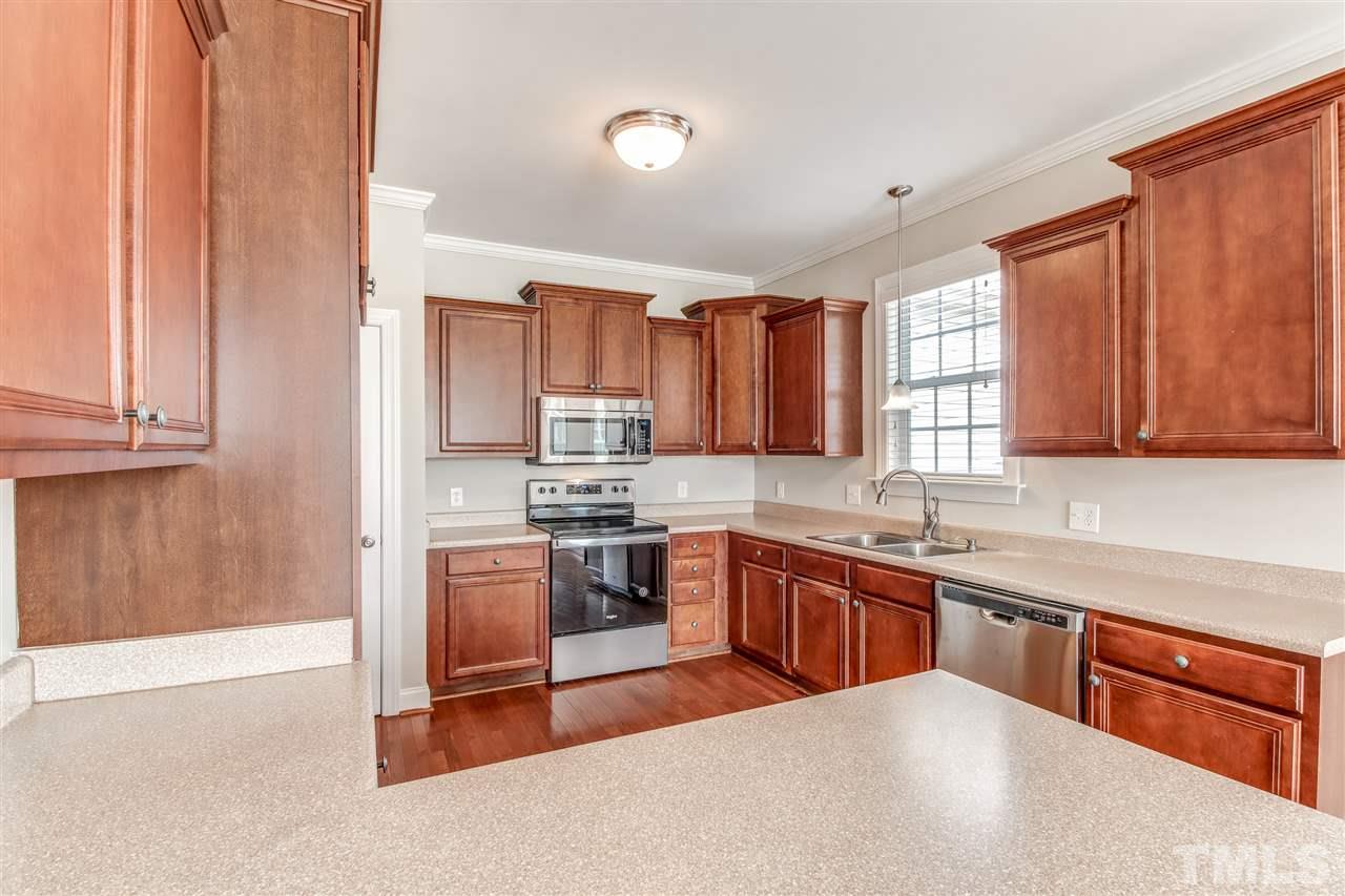 8905 Oregon Inlet Court Raleigh, NC 27603 - Photo 11 of 30 a kitchen with stainless steel appliances granite countertop a stove a sink dishwasher and a refrigerator