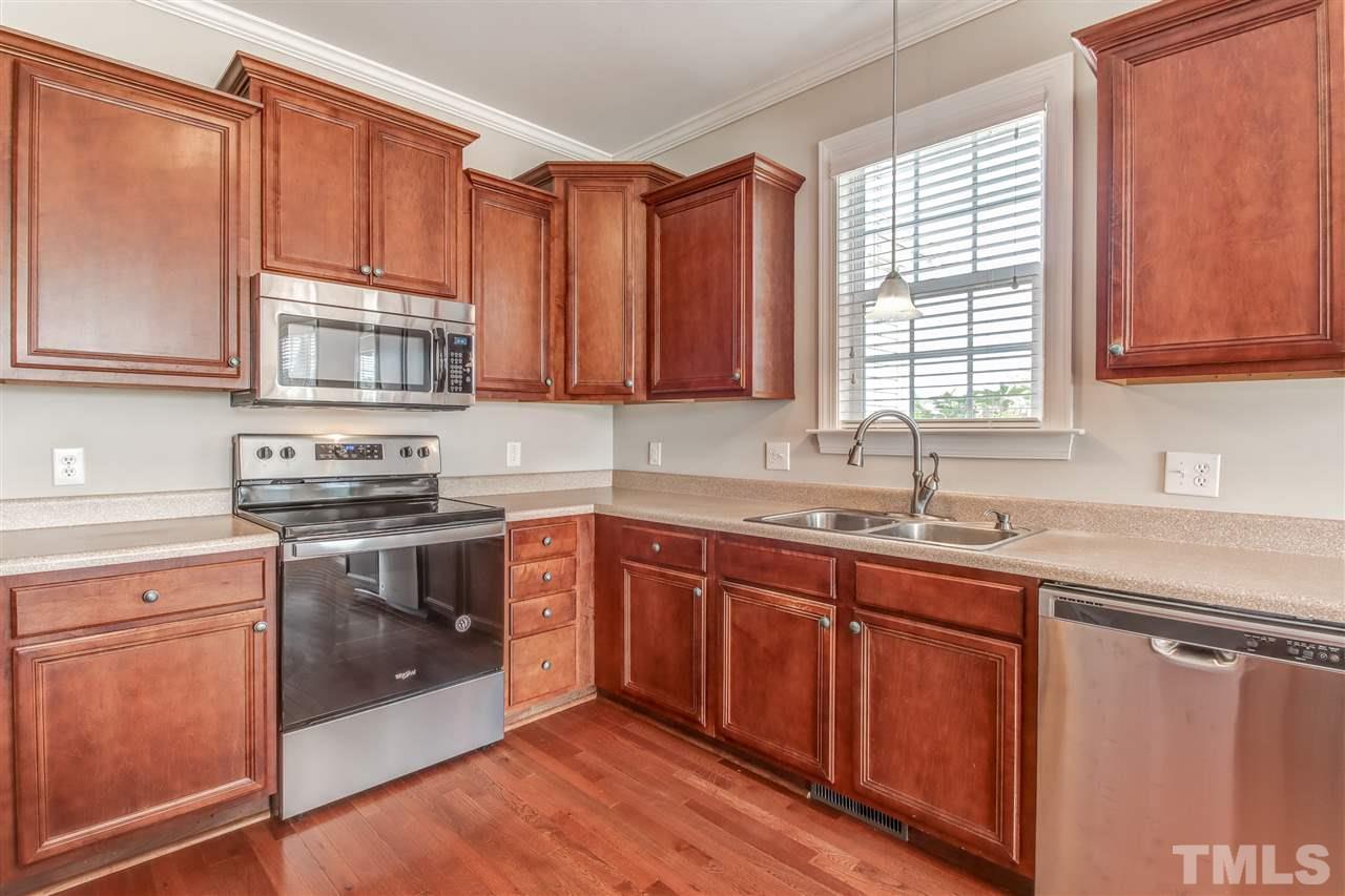 8905 Oregon Inlet Court Raleigh, NC 27603 - Photo 13 of 30 a kitchen with stainless steel appliances granite countertop a sink a stove a microwave and cabinets