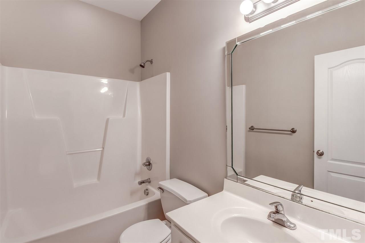 8905 Oregon Inlet Court Raleigh, NC 27603 - Photo 17 of 30 a bathroom with a sink toilet and shower