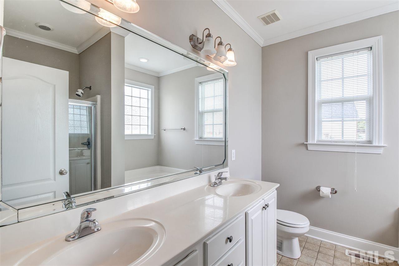 8905 Oregon Inlet Court Raleigh, NC 27603 - Photo 21 of 30 a bathroom with a sink and a toilet