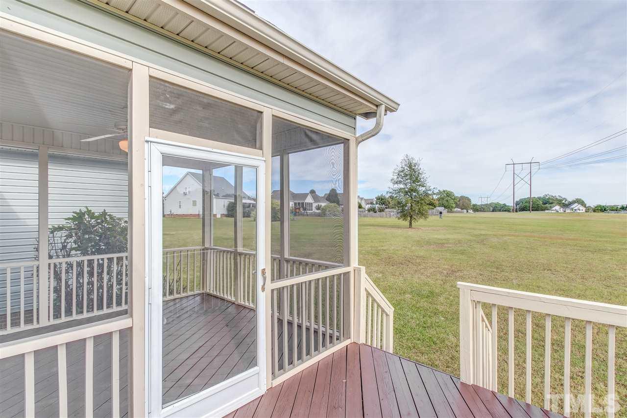 8905 Oregon Inlet Court Raleigh, NC 27603 - Photo 26 of 30 a view of a balcony with floor to ceiling window wooden floor and fence