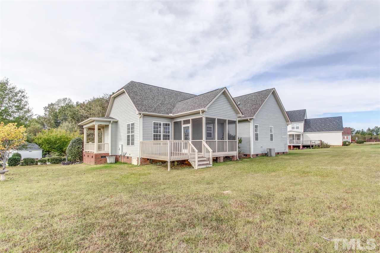 8905 Oregon Inlet Court Raleigh, NC 27603 - Photo 28 of 30 a view of a house with a yard and sitting area