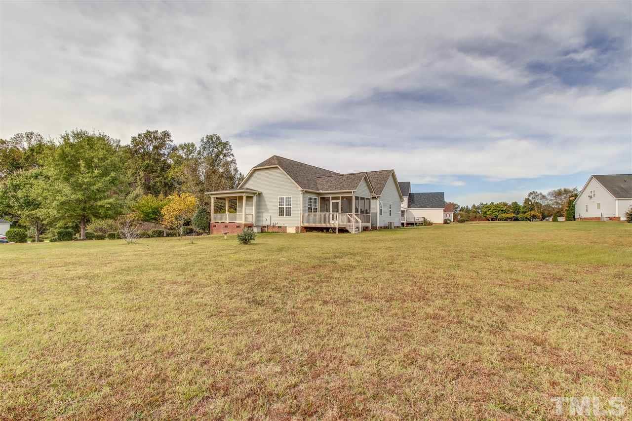 8905 Oregon Inlet Court Raleigh, NC 27603 - Photo 29 of 30 a view of house with yard and ocean view