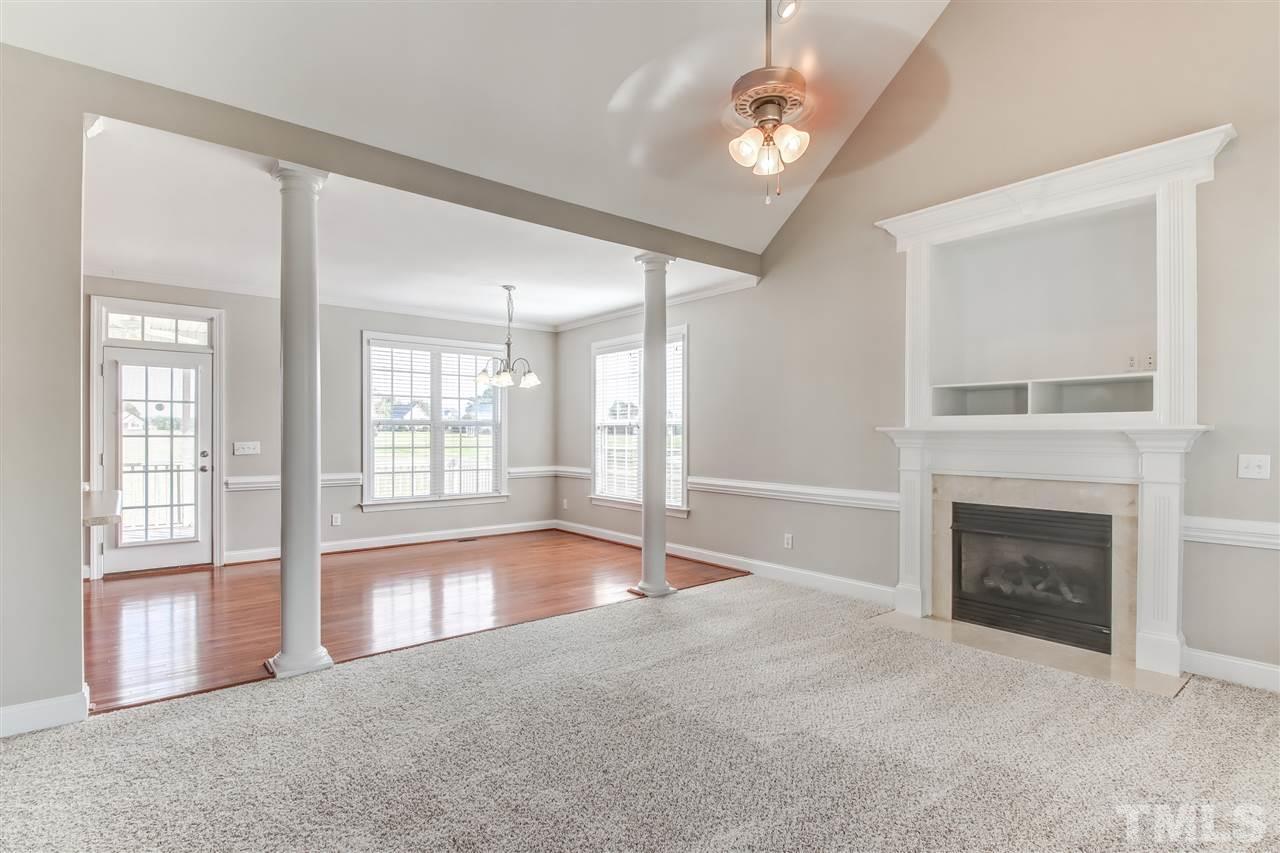 8905 Oregon Inlet Court Raleigh, NC 27603 - Photo 4 of 30 a view of an empty room with a fireplace and a window