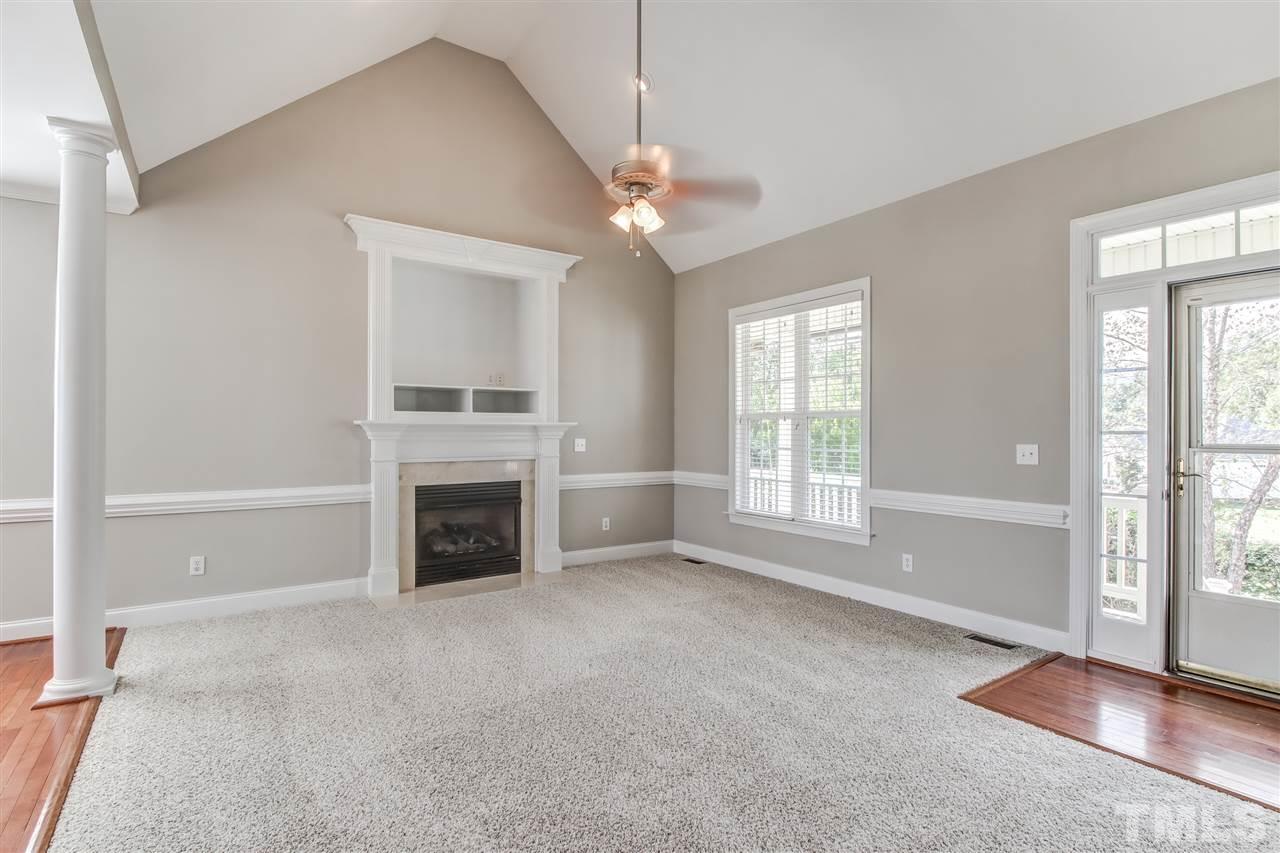8905 Oregon Inlet Court Raleigh, NC 27603 - Photo 5 of 30 a view of a livingroom with a fireplace ceiling fan and windows