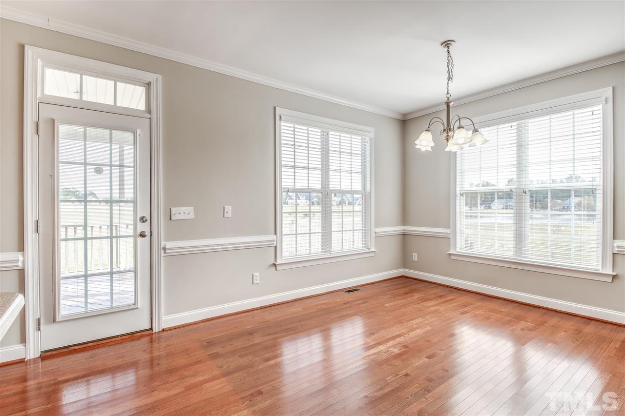 8905 Oregon Inlet Court Raleigh, NC 27603 - Photo 10 of 30 a view of an empty room with wooden floor and a window