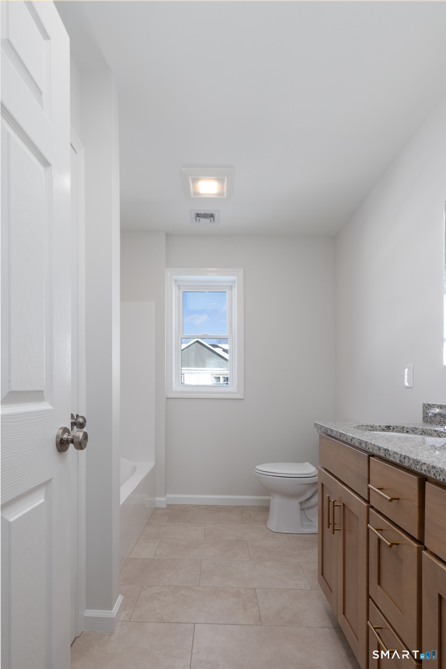 75 High Street Plymouth, CT 06786 - Photo 15 of 17 a bathroom with a granite countertop sink a toilet and a mirror