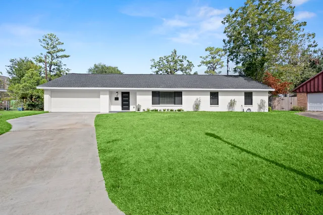 a view of house that has a yard