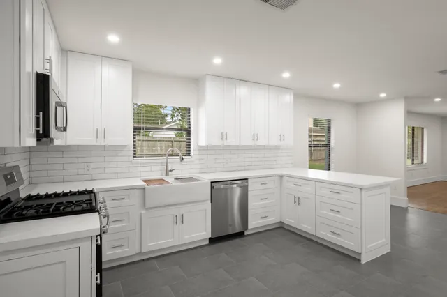 a kitchen that has a sink and a stove in it