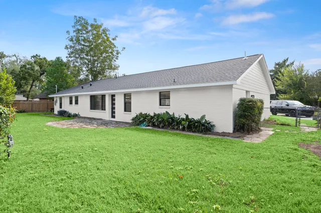 a view of a house with backyard sitting area and garden