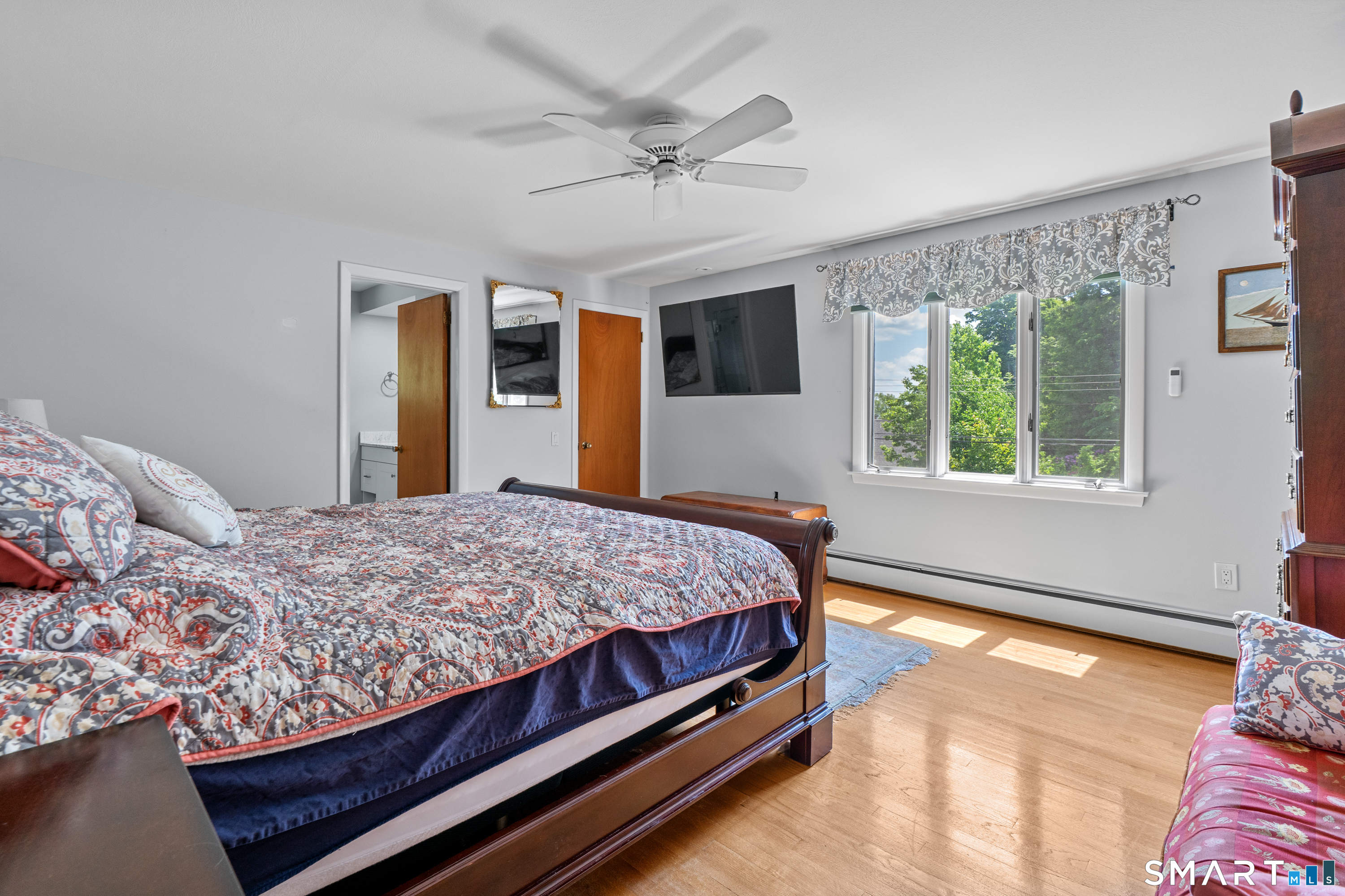 107 Round Hill Road Wethersfield, CT 06109 - Photo 26 of 40 a bed sitting in a bedroom next to a window
