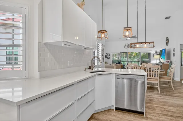 a kitchen with cabinets and chairs