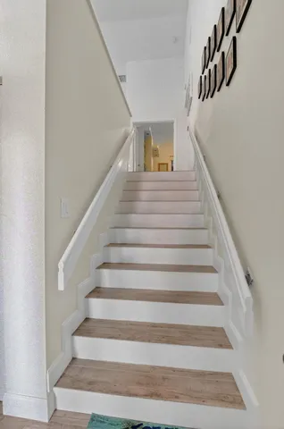 a bathroom with a granite countertop toilet a sink and a mirror