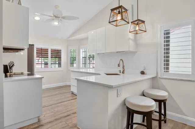 a kitchen with a sink cabinets and window