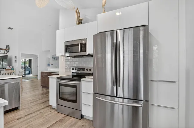 a kitchen with stainless steel appliances a refrigerator stove and microwave