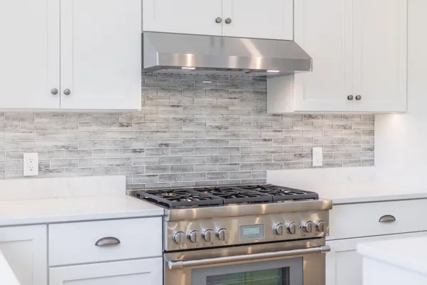 a stove top oven sitting inside of a kitchen