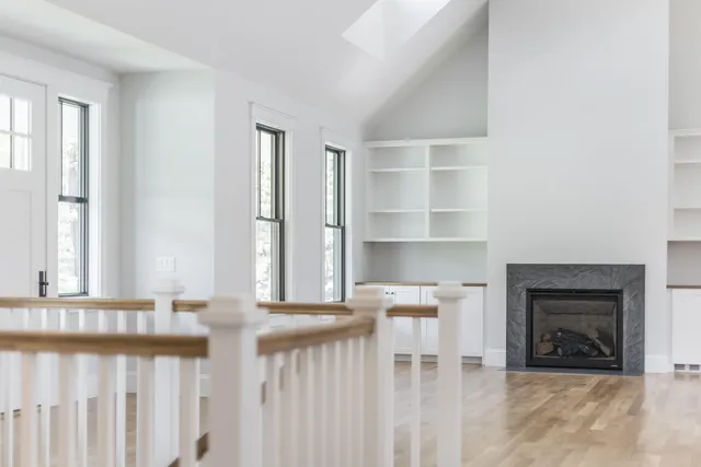 a view of a kitchen with wooden floor and a fireplace