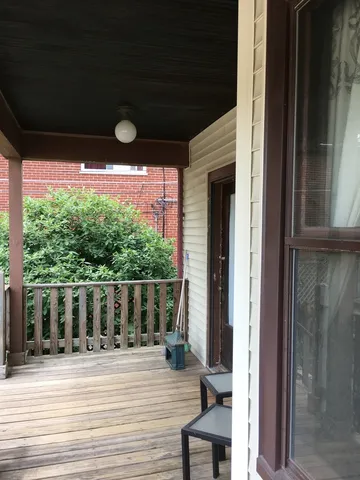 a view of a porch with wooden floor and outdoor space