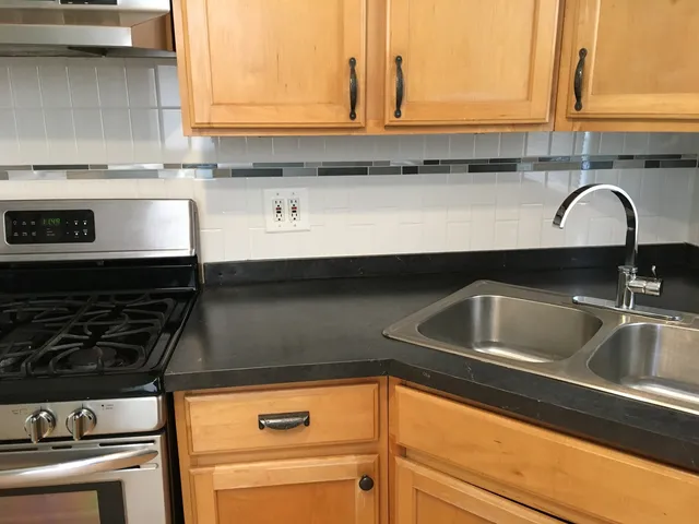 a kitchen with a sink and cabinets