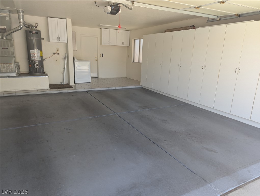 9433 Quail Ridge Drive Las Vegas, NV 89134 - Photo 19 of 23 Functional garage with extensive storage and an organized laundry area.